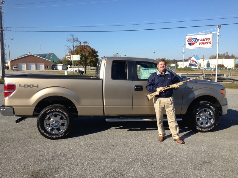 John Bateman of Boulevard Ford stands in front of the Ford pick-up that will be awarded if a winning ticket holder sinks a 50-foot putt during this year's Eastern Sussex Ducks Unlimited Banquet. Bateman also holds the 12-gauge Benelli Super Black Eagle that will be raffled off to help raise funds for waterfowl conservation. BY RAYMOND HARP