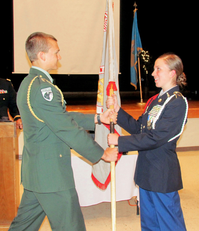 JROTC Battalion Commander Cadet Col. Dylan Varrato of Georgetown hands over the battalion flag to incoming commander Cadet Lt. Col. Kaycee Bean. Signifying the changing of the command, Varrato is dressed in the battalion’s old dress green uniform, and Bean is dressed in the battalion’s new dress blue uniform. SOURCE SUBMITTED