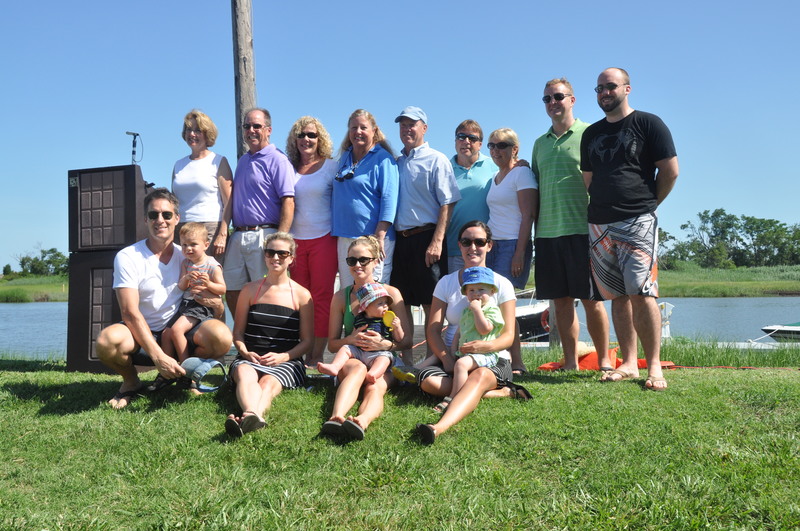 Mason family members and spouses gather for a tribute to J.J. Mason. They are in the back (l-r) Jenny Hopkins, Mase Mason, Laura Mason, Jenkie Lingo, Bill Lingo, Andrew Mason, Anne Mason, Daniel Tyson and Zach Rempfer. In the front are (l-r) Brent Trimble with Benjamin Trimble, Cassie Rempfer, Lindsay Trimble with James Trimble and Samantha Tyson with Skutch Tyson. BY RON MACARTHUR