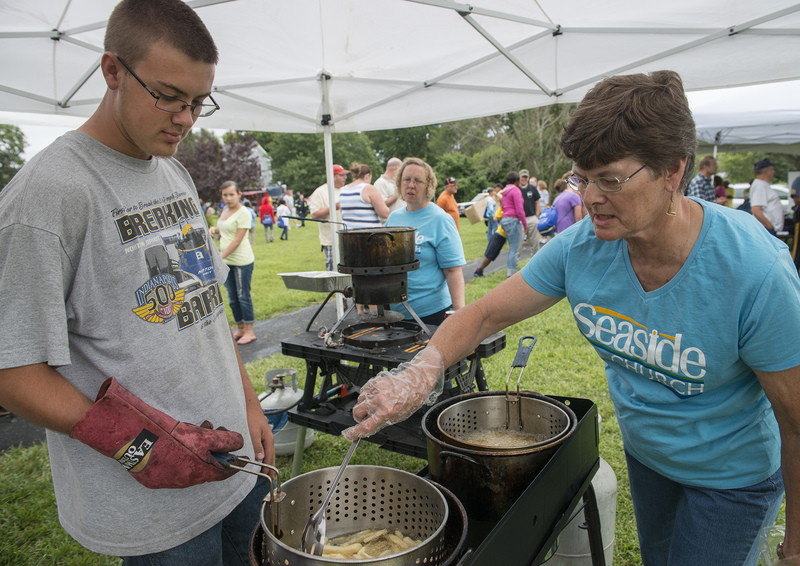 Seaside Church in Nassau participates in National Night Out every year with the popular french fry stand. They go through about 250 pounds of donated fries, and they have a hard time keeping up. Jeffrey Clendaniel and Eileen Furnish keep the fries coming. BY DENY HOWETH
