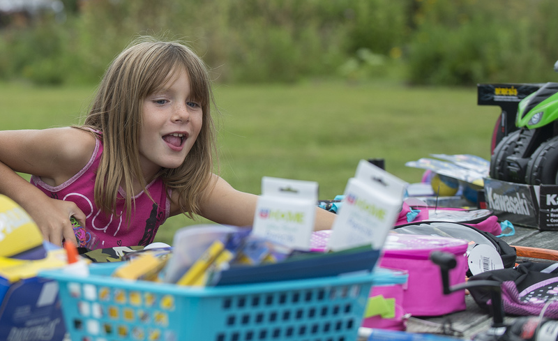 Akyssa Rhoades,8 gets excited by the giveaway table, which included small toys and bicycles, donated by local merchants and some purchased by the city. BY DENY HOWETH