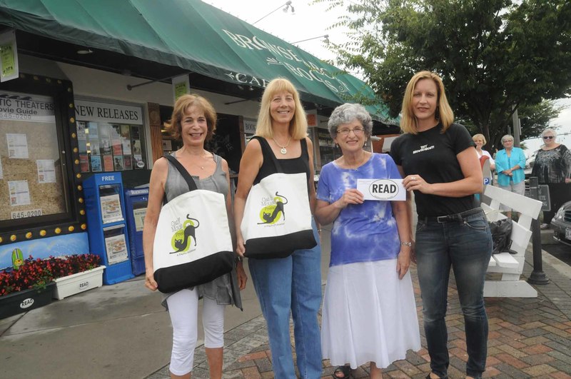 The top winners gathered at Browseabout Books Aug. 22 for the prize presentation. Shown are (l-r) third-prize winner Renay Regardie for "Refuge"; second-prize winner Nancy Powichroski Sherman for "Why You Trashed Vera Wang"; and first-prize winner Sarah Barnett for "Summer of Your Discontent." Presenting the cash award is Susan McAnelly, Browseabout Books manager. PHOTOS BY STEVEN BILLUPS