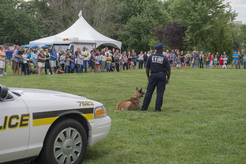 A crowd of three hundred people attended the National Night Out, which included a K-9 demonstration. Milton Police Department K-9 Finn, waits to demonstrate a take-down. BY DENY HOWETH