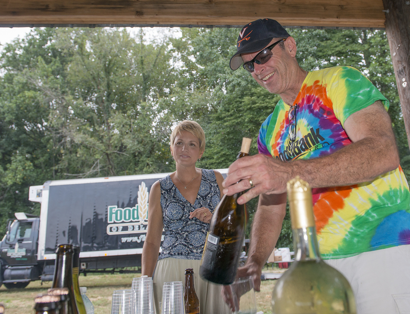 Ed Matarrese, director of facilities with Food Bank of Delaware, was host bartender, while Holly Johnson looks on. BY DENY HOWETH