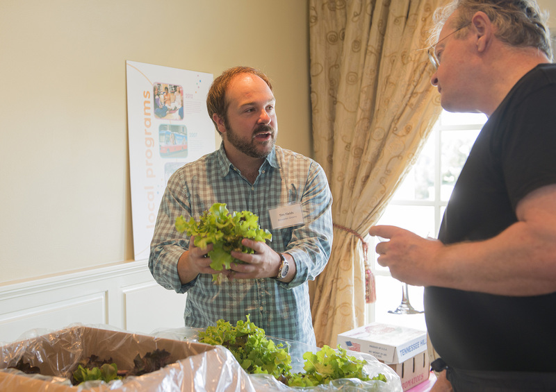 Tim Fields of Baywater Greens discusses his hydropinc greens and their benefits with Otto Tidwell. BY DENY HOWETH