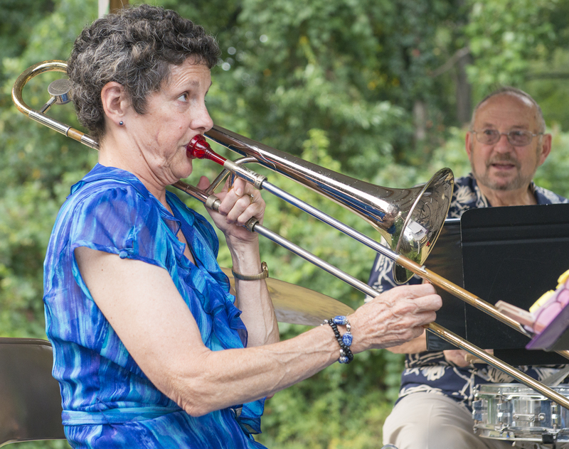 Swing Noteables' trombonist Kay Meade belts out a boogie woogie tune as drummer Arvin Noel looks on. BY DENY HOWETH