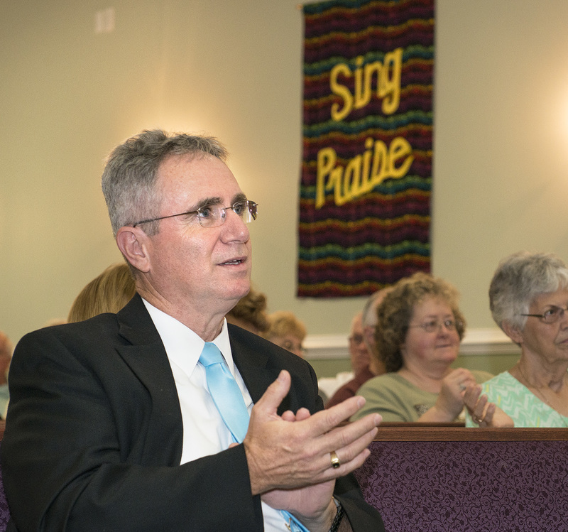 The Rev. Michael Hurley of Conley's United Methodist Church in Angola claps along to a performance. BY DENY HOWETH