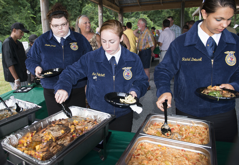 Woodbridge FFA students provided lamb and pork for the event. Rachel Driscoll, left, Iva Pritchett and Lauren Rose partake in the festivities. BY DENY HOWETH