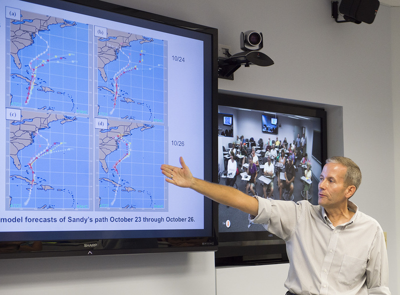 Dan Leathers discusses tropical systems in the Mid-Atlantic and Superstorm Sandy in front of an overflow crowd. BY DENY HOWETH