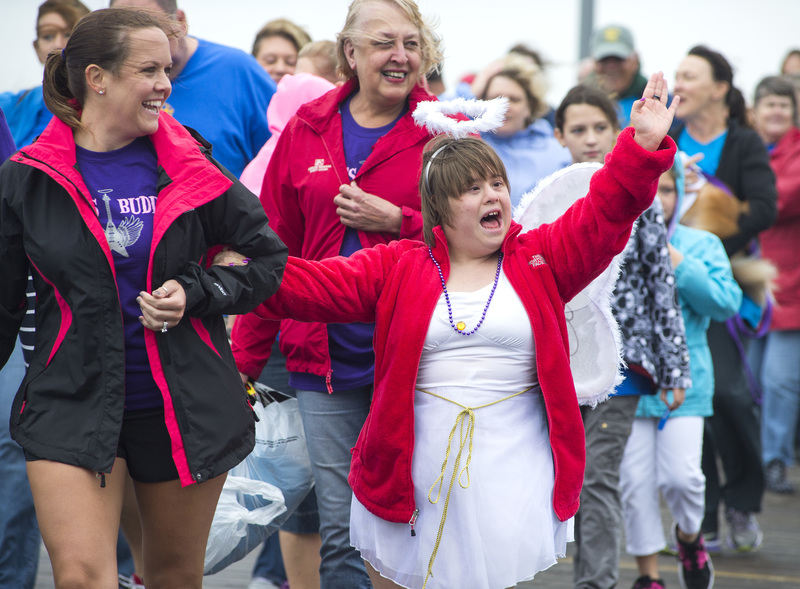 Sarah Hightower, this year's cover girl, makes an appearance at the Boardwalk Buddy Walk. Her sister Lindsay Glaeser and mother Karen Hightower walk with her. BY DENY HOWETH