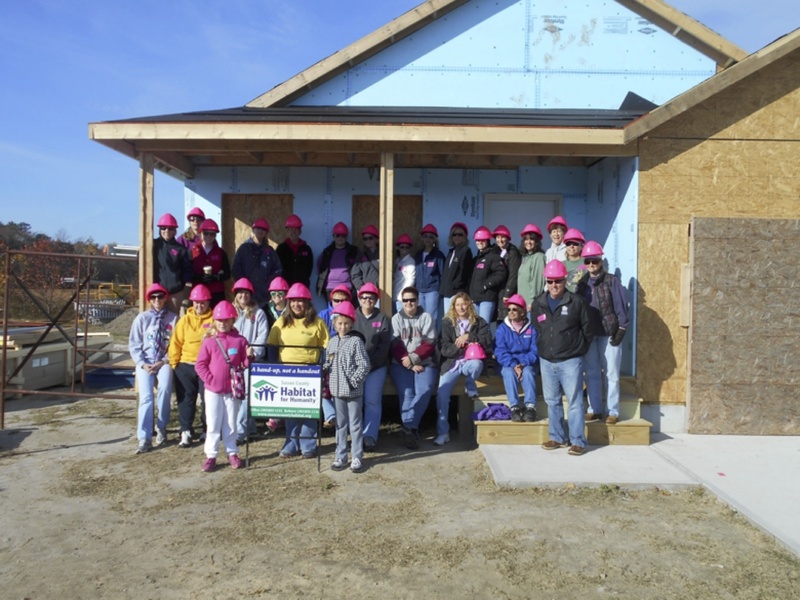 Women Build volunteers include in back (l-r) Sue Pawlikowski, Angela Musser, Kelly McCandless, Barbara Woods, Jill Kupinski, Janna Kirby, Julie Stevenson, Khara Landon (behind post), Nancy Terranova, Victoria Southard, Cheryl Davidson, Karen Killian, Linda Williams and Sandy Sommerfield. In middle row are Gretchen Spraul, Margaret London, Lindsay Williams, Stephanie Hartsoe, Deb Dorris, Karen Dorris, Ruth Sivils, Sharon Lawrence, Stephanie Raffer, Community Engagement Director Tom Protack, and Cindy Scott (behind Protack). In front with sign are Emma Duffield, Sussex Habitat family partner Martiria Mendez and Olivia Duffield. SOURCE SUBMITTED