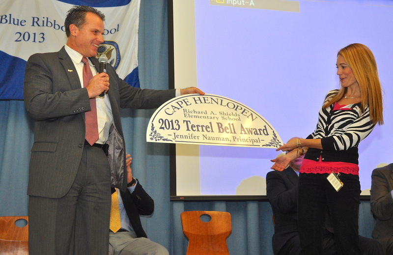 Cape Henlopen School District Superintendent Bob Fulton, left, presents Richard Shields Elementary Principal Jenny Nauman with a sign to be placed over her office door. She is the first Delaware principal to win the national Terrel Bell Award, named in honor of the second U.S. Secretary of Education. BY RON MACARTHUR