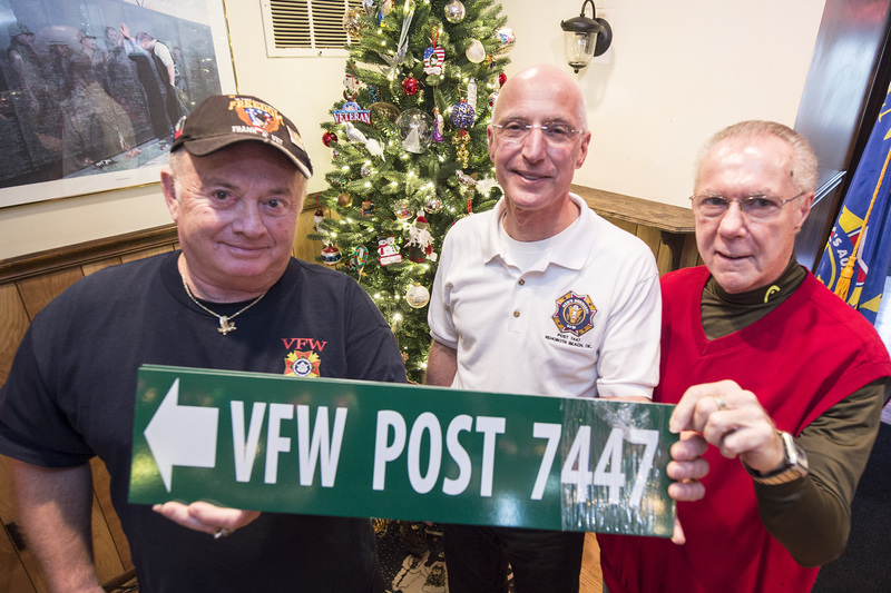 New signs will be posted on Route 1 directing members and guests to VFW Post 7447. Showing the signs are (l-r) Art Frampton, VFW Oost 7447 quartermaster, Ed Schaefer, men's auxiliary president, and Rich Morgante, men's auxiliary treasurer. Sen. Ernie Lopez, R-Lewes, was instrumental in getting the funds allocated for the signage. BY DENY HOWETH
