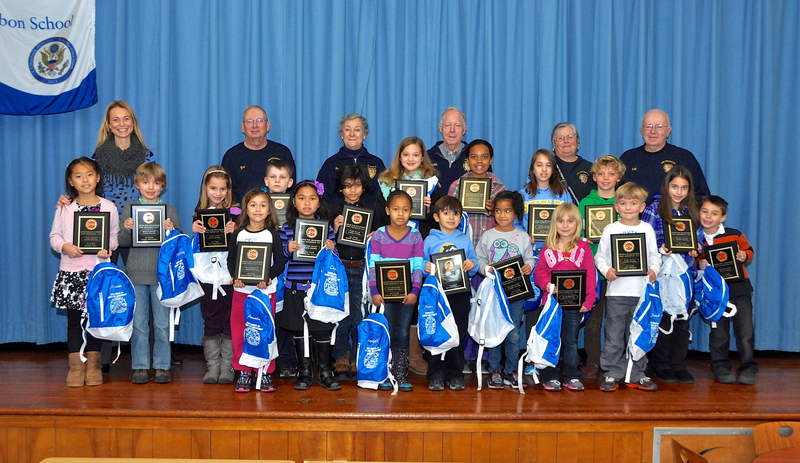 Presenting plaques to winners are (l-r) in the back row, Principal Jenny Naumann and Lewes Fire Department volunteers Don Clemons, Caddie Joseph, Chubbie Joseph, Patty Marvel and Bob Nicholson. Student winners in the middle row are (l-r) Minami Sano, Bailey Fletcher, Ella Marinucci, Ryan Pickard, Krish Prattipati, Else Leebel, Kyla Collick, Mallory Lemin, Gannon Burris, Ashlyn Andrew and Ryan Andrew. In the front row are (l-r) Amanda Lima-Rodriquez, Chelsea Tabaco, Anejah Johnson-Grace, Matthew Yunis, Dayanna Maull, Mallory Terhune and Jack Thomson BY RON MACARTHUR