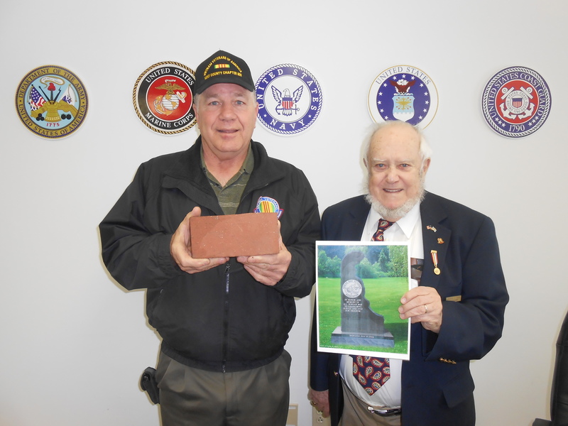 Joe Startt Jr., president of Kent County Chapter 850, Vietnam Veterans of America, left, is shown with Commissioner George Goss, who holds a photo of the planned Korean War Memorial at the Kent County Memorial Park in Dover. Goss is state president of the Korean War Veterans Association. Memorial bricks will be sold to help finance the project. SOURCE SUBMITTED