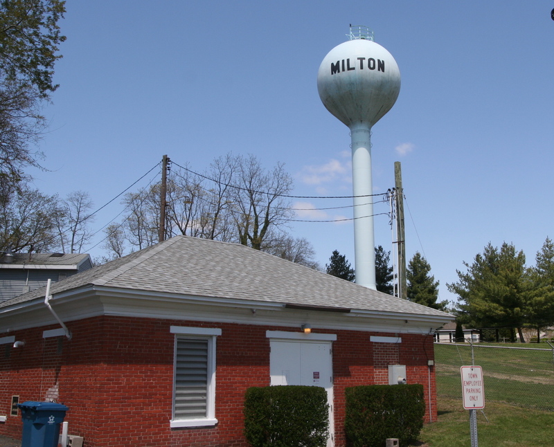 Black aluminum fencing will enclose this Milton Public Works Department water treatment building on Chandler Street, and black chainlink fencing will be used to encircle the water tower. Many town residents say chainlink fencing is ugly, and it will detract from the town’s overall appearance for decades to come. BY HENRY J. EVANS JR.