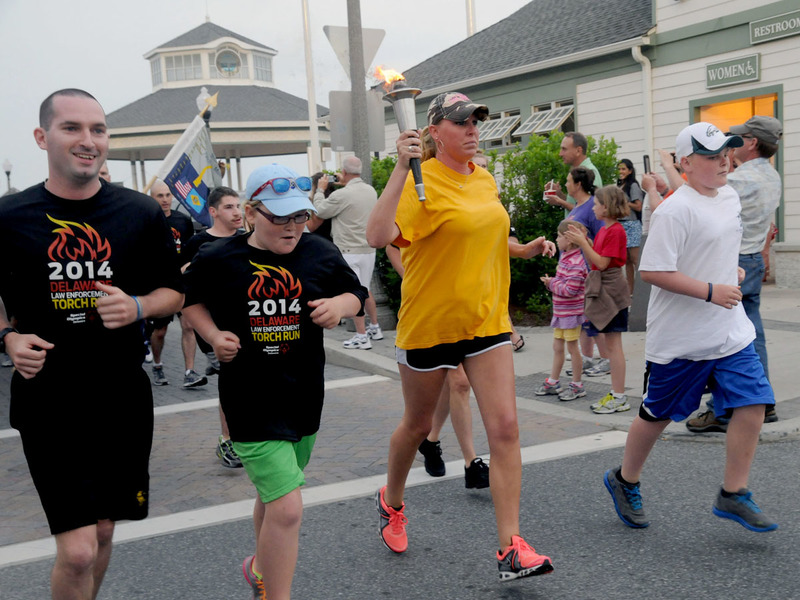 The torch begins it journey with the first mile dedicated to Delaware State Trooper Cpl. Chris Shea who was tragically killed in the line of duty 10 years ago. Carrying the "Flame of Hope" are Shea family members (l-r) brother Andrew Shea, daughter Elizabeth Shea, widow Susan Shea and son Chris Shea Jr. BY STEVEN BILLUPS