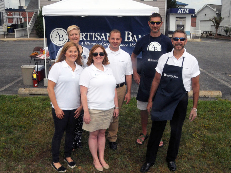 Shown gathered for a group photo are in back (l-r) Mimi Pickrell, Millville branch manager; Harry Maichle, customer service representative; and Bryan Bare, barbecuer. In front are Kristin Rogers, teller; Bethany Lewis, financial consultant; and Ken Beaudean, Rehoboth branch manager. BY STEVEN BILLUPS