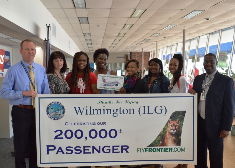 Kathy Clark, holding card, wins a $500 Frontier gift card as the 200,000th passenger to travel through Wilmington Airport. Joining Clark are (l-r) Wilmington Airport Manager Ben Clendaniel; Maggie Liberato, Frontier station manager; Kaitlin Clark; Ashley Lindsey; Simone Jones; Whitley Grant; and Delaware River and Bay Authority Airports Director Stephen Williams. SOURCE SUBMITTED