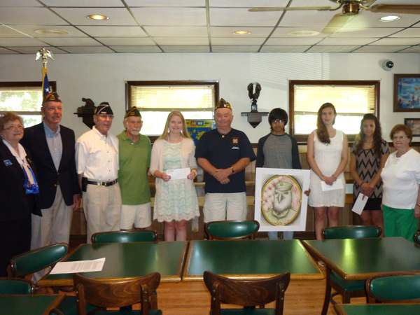 Rehoboth VFW Post 7447 Scholarship Committee members presented scholarships and recognized statewide honors on Flag Day, June 14. Gathered at the ceremony are Ladies' Auxiliary member Barbara McGowan; John Barlow, post chairman; Ed Schaefer, Men's Auxiliary; new Post Commander Robert McGinniss; at-large scholarship winner Sarah Bell; Post Quartermaster Art Frampton; state VFW Ladies Auxiliary Young American Creative Patriotic Art winner Francisco Madera; post-affiliated scholarship winners Brenna Gause and Irelynn Donovan; and Ladies' Auxiliary President Elsie McGurgan. SOURCE SUBMITTED