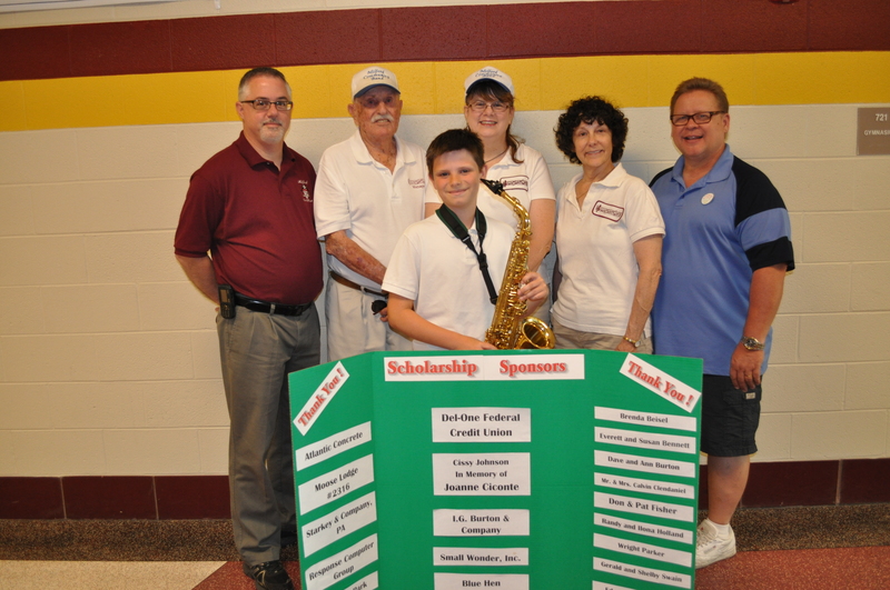 Parker Maull, tenor sax player, stands with with members of the MCB selection committee (l-r) MSD Elementary band director Todd Mentzer, Milford Community Band founder Joe Lear, Laura Herbin, Selection Committee Chair Kay Meade and Milford Central Academy band director Wayne Smith. Not pictured is Payton McKellop, trombone player. SOURCE SUBMITTED