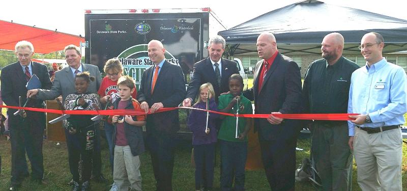 Science at Your Door mobile laboratory was unveiled at a ribbon-cutting. Shown are in back (l-r) Steven Godowsky, David Small, Jack Markell, EPA Regional Administrator Shawn M. Garvin, Laurel Schools Superintendent Shawn Larrimore; educator interpreter Will Koth; and Jonathan Wickert, chief of interpretation, Delaware State Parks. In front are Laurel North Elementary School students Zamaya Horsey, Zoe Gianacopolis, Brandon Adkins and LaTonn Palmer. SUBMITTED PHOTO