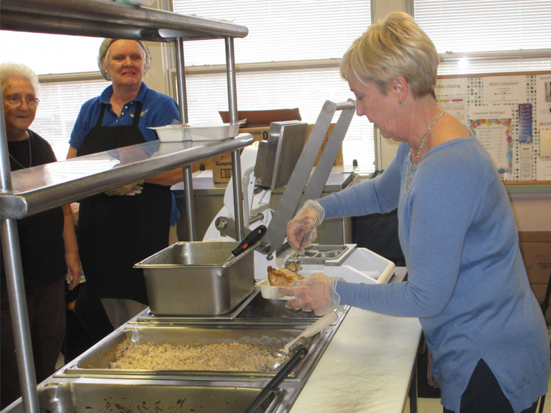 State Rep. Ruth Briggs Kings, R-Georgetown, right, helped package food for last year's Meals on Wheels March for delivery. Keeping a watchful eye on the process were, at left, Florence Mason, CHEER nutrition director, and Barbara Aro, kitchen manager at CHEER's Georgetown Activity Center. SUBMITTED PHOTO