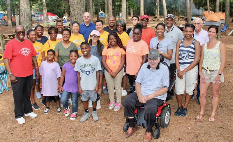 Among those joining Gov. Carney at Trap Pond State Park for the Great American Campout were these members of the MERIT program and their families and supporters. Shown in back are (l-r) Kianna Kelley, Orlando Kelley Jr., Sussex County Council President Michael Vincent, Orlando Kelley Sr., and Jordan Clark. In the next row are Joy Baker (yellow shirt), Rosalyn Baker, Shorel Clark, David Hall, Yolanda Hutson, Joe Hutson, Jerome "Skip" Hutson, and longtime state parks advocate and former state Sen. Robert Venables. In the third row are Monica Kelley (green shirt) and Jeanae Clark. In the second row are Diaz J. Bonville, program director for the West Rehoboth Children and Youth Program, in the red MERIT shirt; Lemuel Chester, Dashel Scarborough-Collick, Osiah Kelley, Jasmine Finney, Marian Kellam, Chelina Tirrell, Jere Hutson and Sen. Venables’ daughter Jeanne Wood. In front is longtime MERIT sponsor, leader and shepherd John Hollis. DENNIS FORNEY PHOTOS