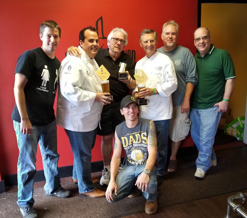 The judges for Cheesetoberfest at Fordham & Dominion Brewery were (l-r), Eric Krauss, head chef at Frankies Italian Restaurant at Dover Downs; certified executive chef, pastry chef & culinary educator/American Culinary Federation Phil Cropper; some guy from downstate; Fordham & Dominion Operations Manager Dan Louder (kneeling); Chef Ed Hennessey, head of Culinary Education at Delaware Technical & Community College in Dover; celebrated BBQ cookoff judge “Chopper” Chuck Regner, and Craig Horleman, Features and Entertainment editor for DE State News.