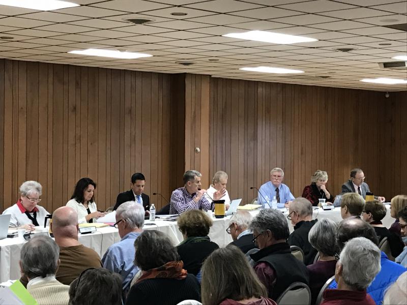 Following a Dec. 2 town hall in which citizens made clear their disdain for the idea granting people whose property is held in an LLC the right to vote, the Rehoboth Beach commissioners decided to table that measure, but they plan to continue work on a package of charter changes to submit to the Delaware Legislature. Shown at the town hall are Rehoboth commissioners (l-r) Toni Sharp and Kathy McGuiness, City Solicitor Glenn Mandalas, Mayor Paul Kuhns, City Manager Sharon Lynn, and commissioners Stan Mills, Lisa Schlosser and Jay Lagree.