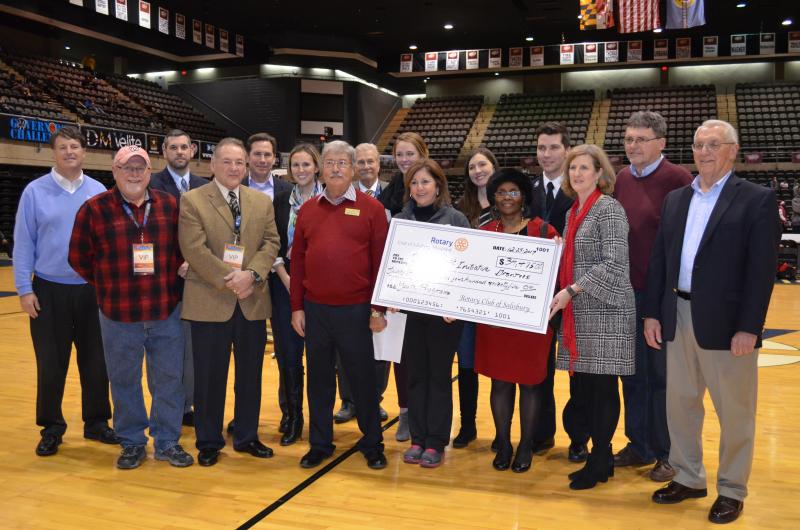The Rotary Club of Salisbury announced the recipients of the 3 Point Initiative Grant funding on Dec. 29 at the Wicomico Youth & Civic Center during the Governor’s Challenge basketball tournament, sponsored by The Bank of Delmarva. In the back row, from left to right, are Carl Cottingham (The Bank of Delmarva), Jason Miller (Prince Street Elementary School), Mark Granger (Donnie Williams Foundation), Alison Grice (Salisbury Art Space), Lennart Elmlund (Salisbury Art Space), Allison Merriken (Epoch Dream Center), Samantha Scott (1 Year to Empowerment), Konstantin Maslenikov (The Salvation Army), Dan Williams (Rotary Club of Salisbury) and Terry Greenwood (Rotary Club of Salisbury). In the front row, from left to right, are Roger Follebout (Rotary Club of Salisbury), Hal Chernoff (Main Street Gym), Kurt Schuster (Rotary Club of Salisbury), Kathleen Momme (United Way of the Lower Eastern Shore), Alexis Dashield (Fruitland Community Center) and Teresa McCain (Horizons Salisbury). Governor’s Challenge, Governor’s Challenge Basketball Tournament, Wicomico County Tourism, WIcomico, Salisbury, Rotary Club of Salisbury, Imagination Library, Epoch Dream Center, 1 Year to Empowerment, Salisbury Art Space, Main Street Gym, Horizons Salisbury, The Salvation Army Youth Club, Prince Street Elementary School, Fruitland Community Center