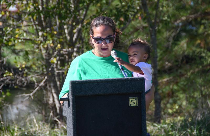 Ashley Collins reads the poem “Love Still Grows and Sweetens” by Phyllis Hall as her daughter Topanga helps.