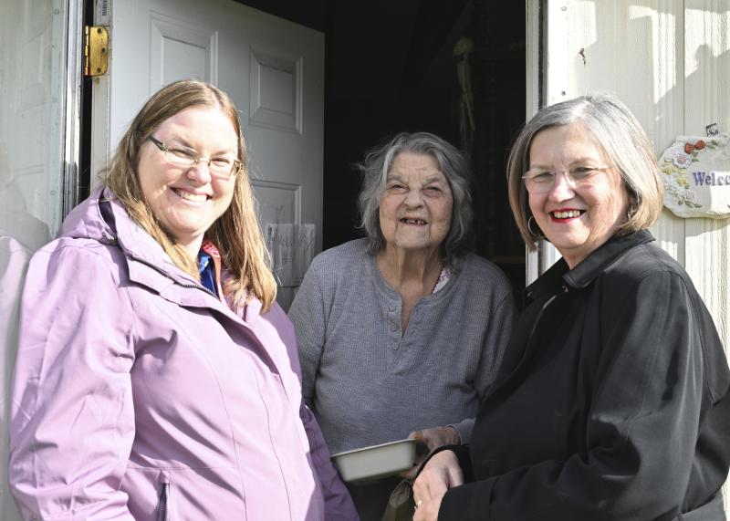 Patricia Glennon receives a hot meal from Megan Jordan, CHEER Nutrition Program administrative assistant, and Susan Dubb, Meals on Wheels Delaware development director. Shown are (l-r) Jordan, Glennon and Dubb.