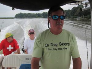 Coakley team captain Mike Coakley heads downriver to a catfish hotspot while Tom Herr, left, and Mike Pearce rest up for the next angling foray.