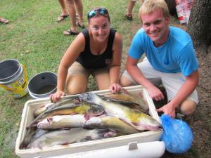 Allison Hall and Craig Fleetwood prepare a cooler-load of catfish for distribution to catfish fanciers in the surrounding area.