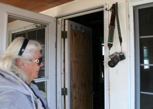 Ronnie Loesch admires a camera that she recovered when she returned to her home after Hurricane Sandy had flooded it with eight feet of water. BY PAT IRELAN