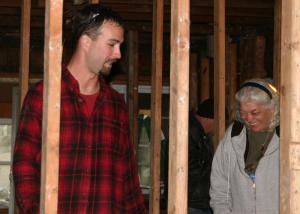 Southern Delaware resident Mike Schimmel gives a hopeful Ronnie Loesch a tour of her freshly gutted house on Staten Island. BY PAT IRELAN
