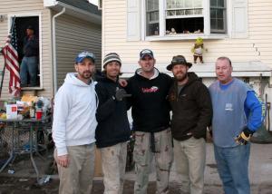 The framing crew of (l-r) Ed Evans, Paul Camenisch, Brad Denney, Kyle Howard and Billy Huckenmeyer celebrate a successful day of rebuilding part of a Staten Island home. BY PAT IRELAN