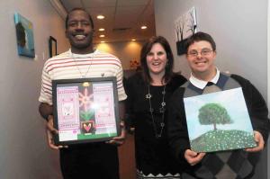 Members of the Salvation Army Creative heArts program show their art that was on display at the event. Shown are (l-r) Marvin Walsh holding his Flowers in the Window” inspired by Henri Matisse; Christy Cugno, Salvation Army director; and Todd Myer with his “Under the Apple Tree.” BY STEVEN BILLUPS