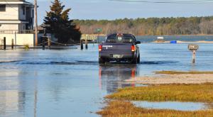 This driver seems to be heading for Rehoboth Bay as he travels on Read Street in Dewey Beach. Many of the roads along the bay were flooded by high tides accompanying the nor'easter. BY RON MACARTHUR