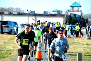 The start of the chip-timed Shamrock Shuffle 5K and 15K shows that runners all start together and are sorted out at the finish chute. The race is seconds old, and the first- and second-place finishers in the 15K, Brock Waughton and Chris Cusmano, have already established location. BY DAVE FREDERICK