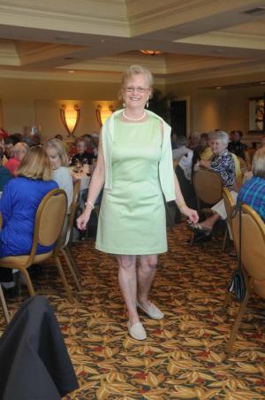 Wearing an outfit from Brooks Brothers is Patricia Van Acken. She is wearing a lime green sleeveless dress paired with an argyle V-neck sweater. BY STEVEN BILLUPS
