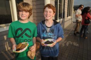 Epworth alumni Ethan Redefer, left, and Finbar Rishko load up with cookies as they head for the playground. BY STEVEN BILLUPS