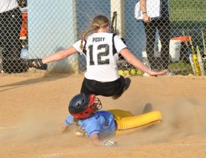 Cape's Kira Vitella slides safely under Tech's Emily Pusey for the game-tying run in the bottom of the seventh inning. BY NICK ROTH