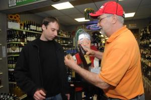 R&L Liquors served up samples of a special Corona beer. Shown is Chris Johnson, left, of Lewes getting a taste of the special beer from R&L employee Tom Greenwood. BY STEVEN BILLUPS