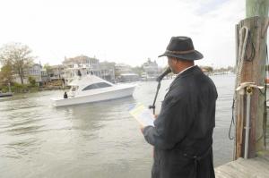 Shown giving a blessing to the ship Portabella, captained by Tom Smith, is the Rev. Ouemonde Brangman from New Zion AME in Milton. BY STEVEN BILLUPS