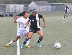 Sussex Tech sophomore Michelle Laz and Cape sophomore Joanne Garcia battle for a loose ball. BY NICK ROTH
