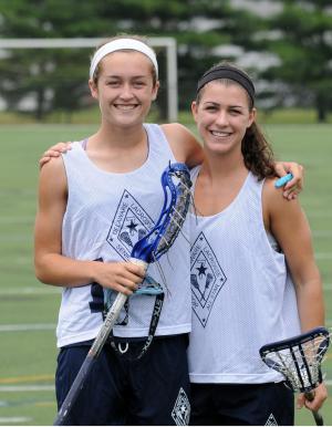 Best friends and teammates Anna Frederick, left, and Sara Young ended their high school lacrosse careers playing in the Delaware Senior All-Star game June 8 at Wesley College. BY DAN COOK