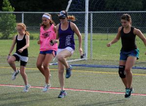 Carrie Lingo leads a group in knee raises and butt kickers. Shown are (l-r) Maci Long, Cassidy Best, Lingo and Camryn Bernheimer. BY DAN COOK