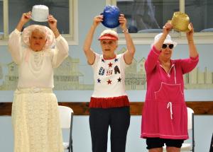 Practicing the Calendar Girls routine are (l-r) Ginny Soule as Miss June, Barbara Henriksen as Miss July and Louise Lewis as Miss August.